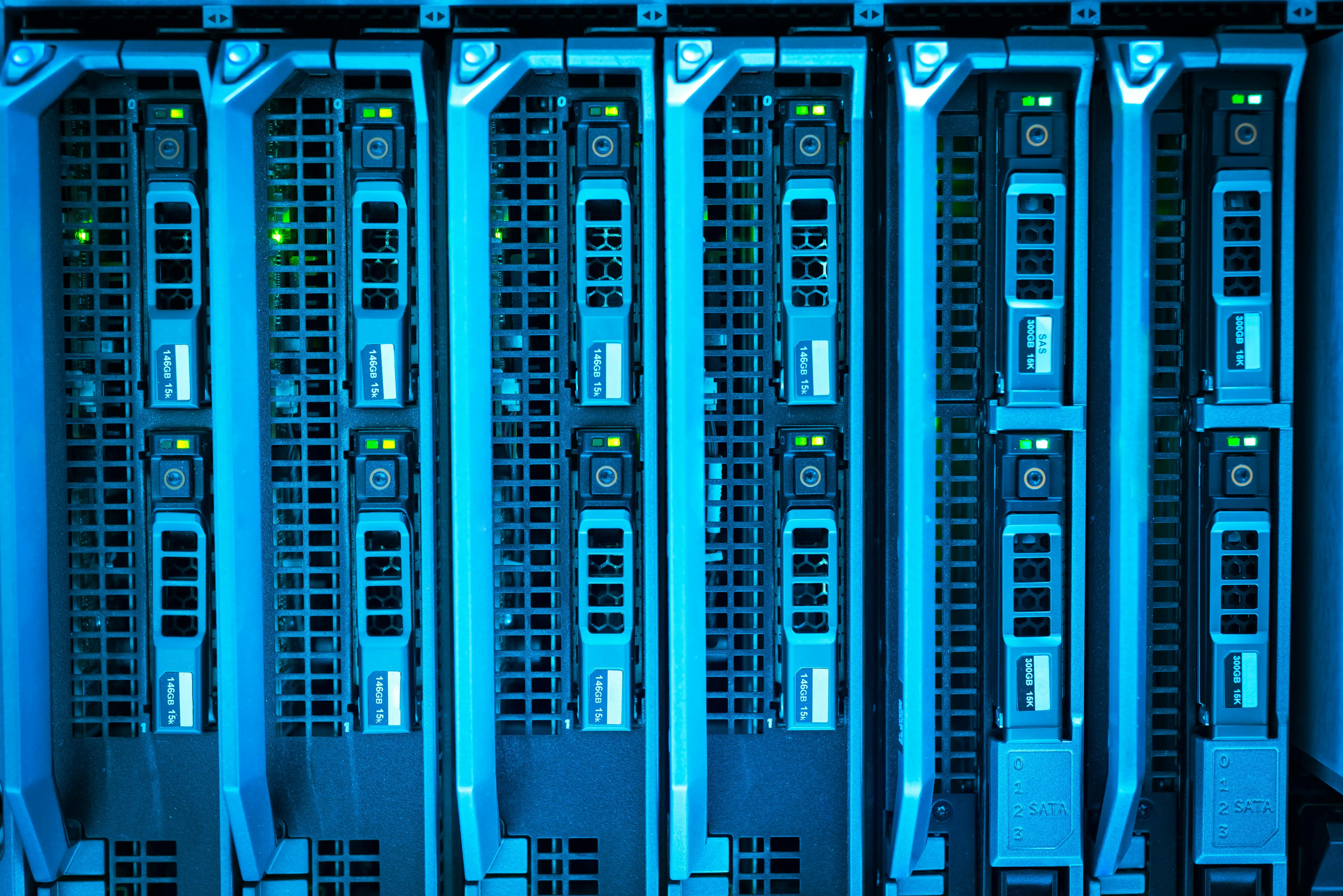 A bank of blade servers seated in a chassis, lit blue.